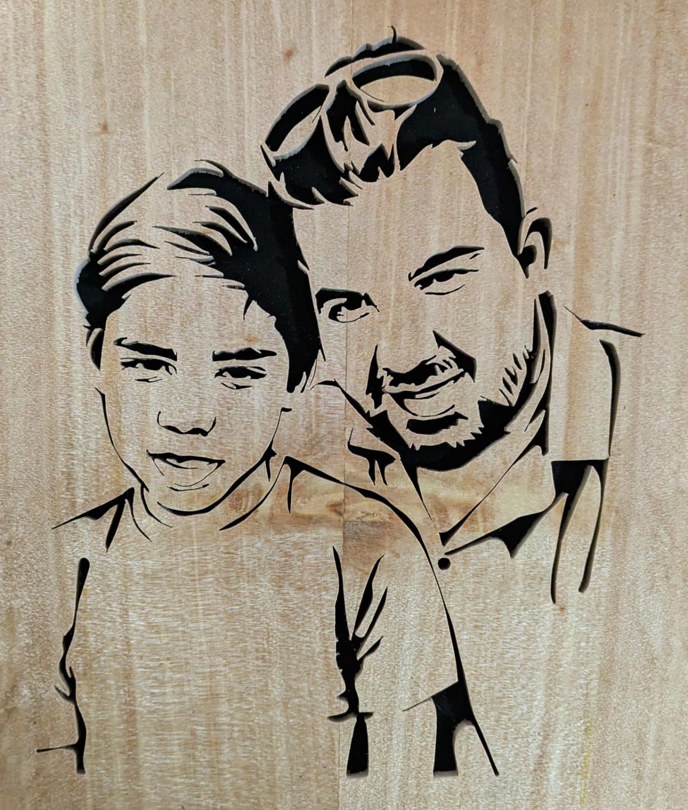 Custom wooden portrait of father and son from a photo. Personalized family wood carving.
