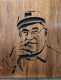 Handcrafted wooden portrait of an elderly man with glasses and cap, custom wood art.