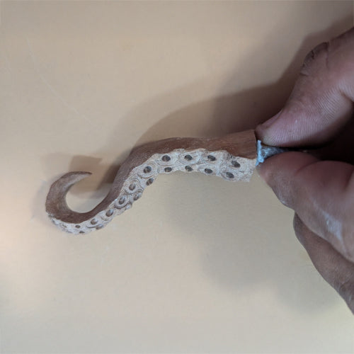 Hand-carved octopus tentacle mug holder made from walnut wood. Unique and functional art piece